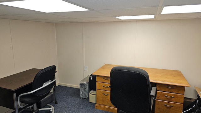 carpeted office space with a paneled ceiling