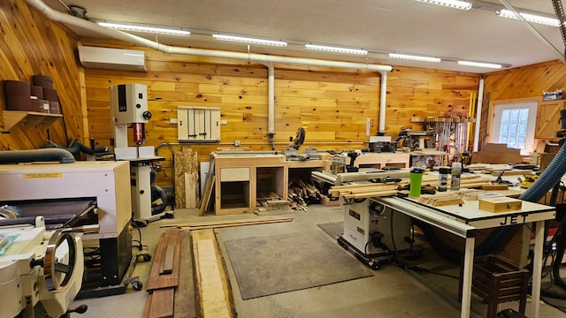 interior space with wooden walls, a workshop area, and a wall mounted AC