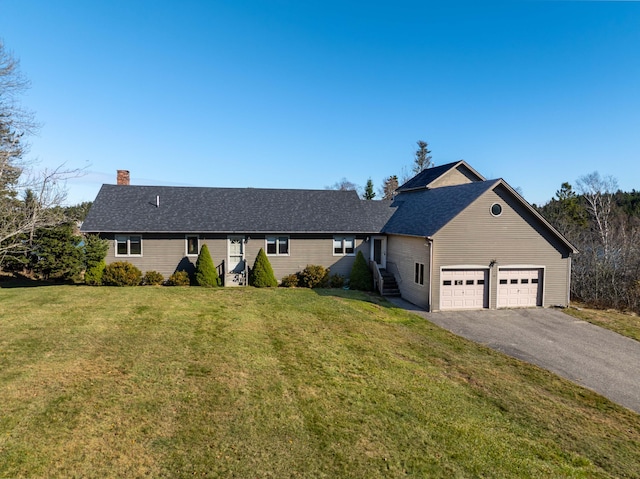 ranch-style house featuring a garage and a front lawn