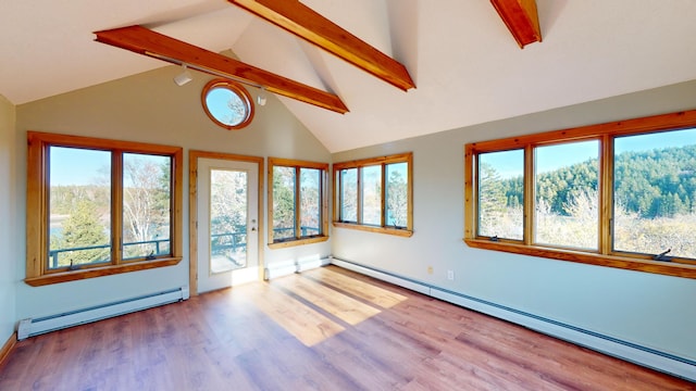 interior space featuring lofted ceiling with beams and a baseboard radiator