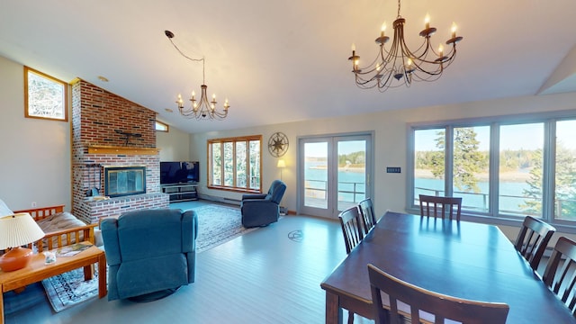 living room featuring a fireplace, a chandelier, high vaulted ceiling, and hardwood / wood-style floors