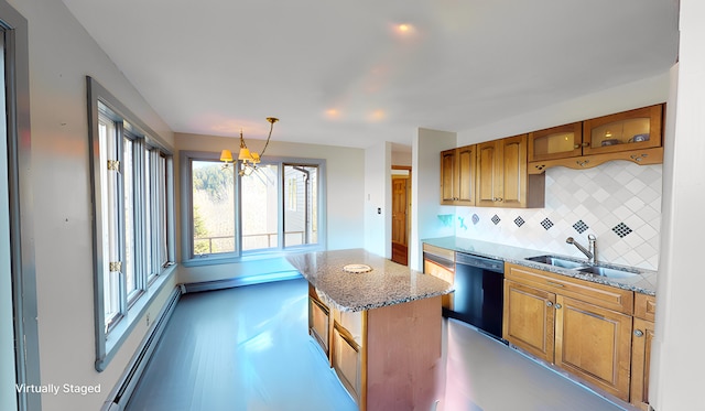 kitchen featuring backsplash, black dishwasher, hanging light fixtures, sink, and a center island