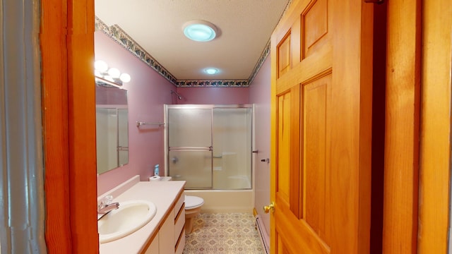 full bathroom featuring enclosed tub / shower combo, vanity, toilet, and a textured ceiling