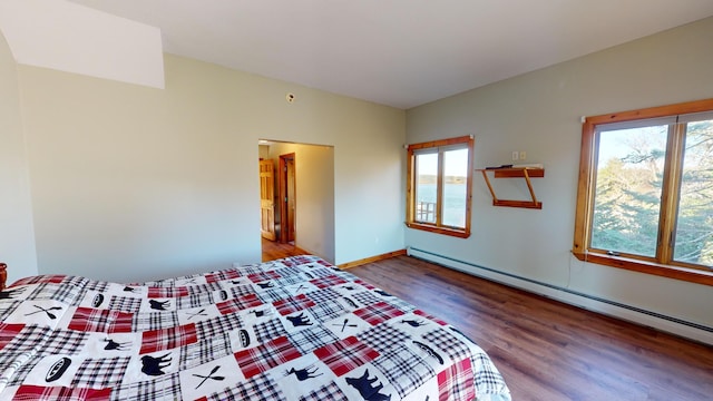 unfurnished bedroom featuring multiple windows, wood-type flooring, and a baseboard radiator