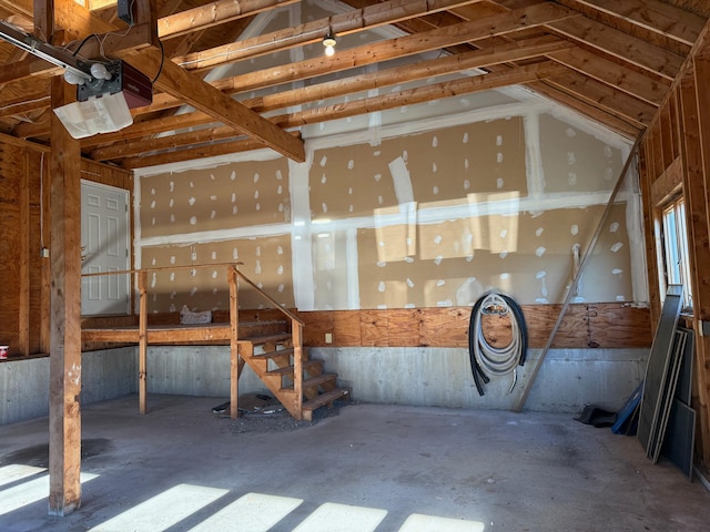 misc room with concrete flooring and lofted ceiling