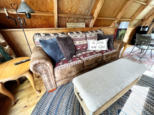 living room featuring wood-type flooring and wooden walls