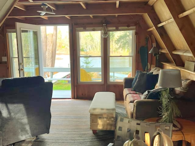 sunroom featuring a wealth of natural light and vaulted ceiling