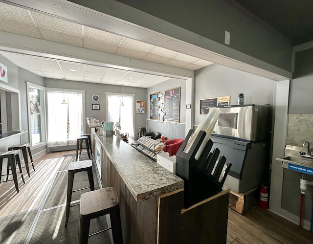 kitchen featuring hardwood / wood-style flooring and a paneled ceiling