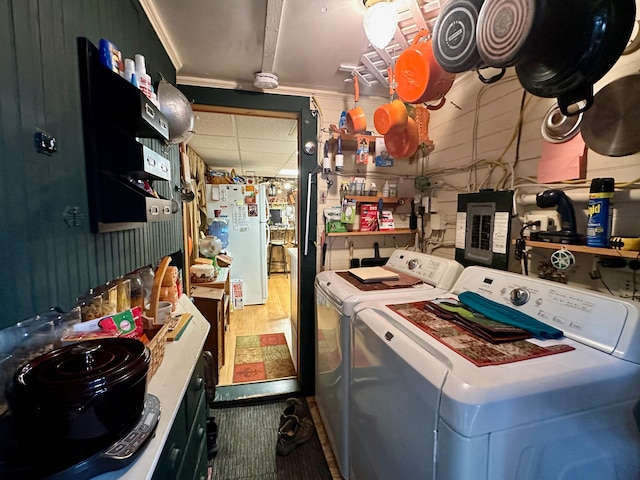 kitchen with washer and clothes dryer, white refrigerator, and ornamental molding