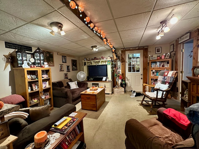 living room featuring a paneled ceiling and carpet flooring