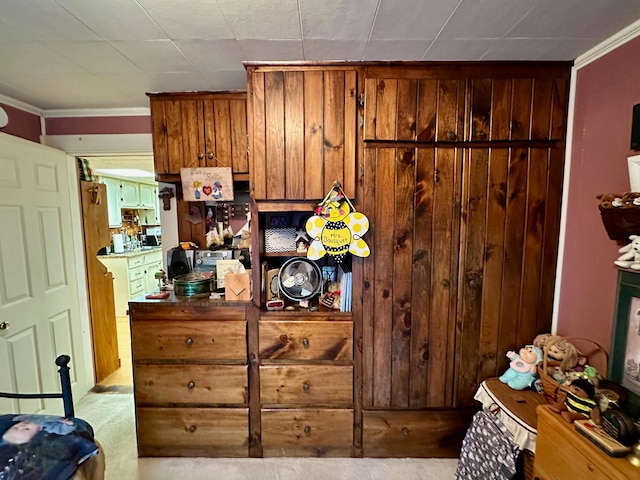 kitchen with light carpet and crown molding