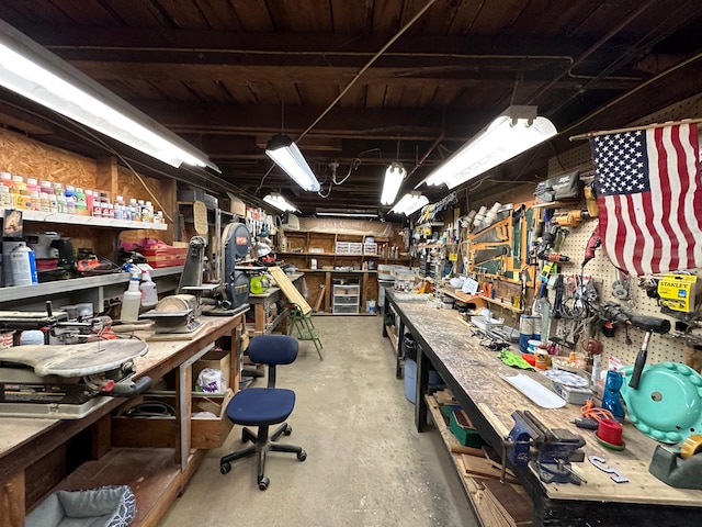 miscellaneous room with a workshop area and concrete floors