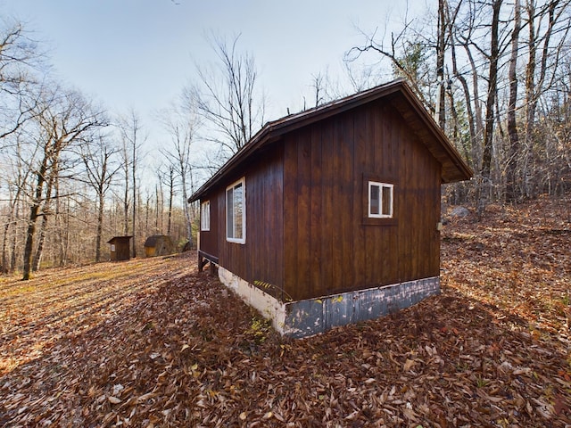 view of property exterior featuring a shed