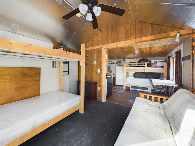 bedroom featuring lofted ceiling, wooden walls, and ceiling fan