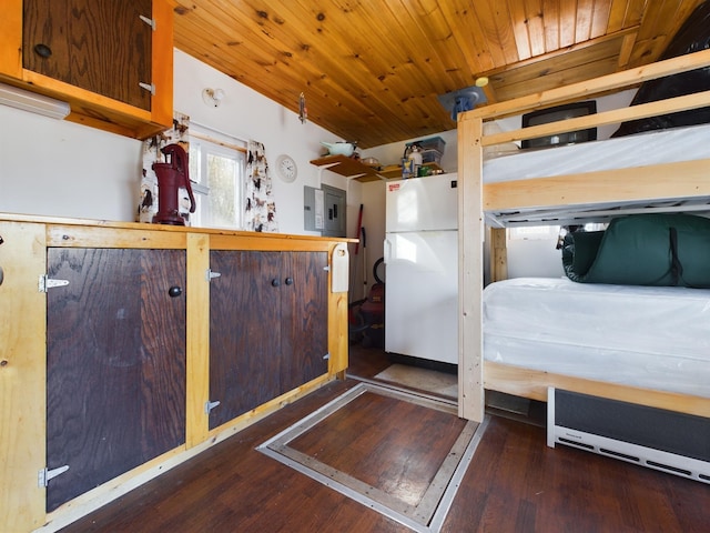 unfurnished bedroom with white refrigerator and dark hardwood / wood-style floors