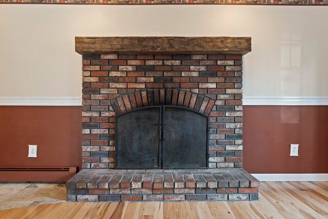 details with hardwood / wood-style floors and baseboard heating