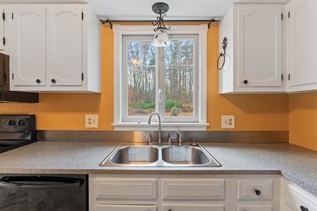 kitchen with decorative light fixtures, white cabinetry, sink, and a healthy amount of sunlight