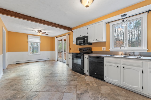 kitchen featuring white cabinets, baseboard heating, black appliances, and sink