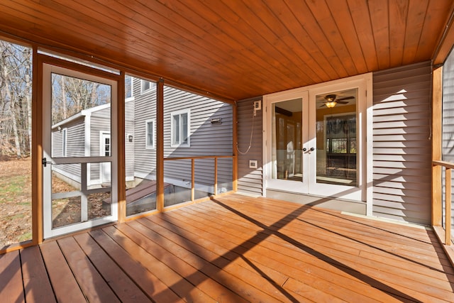 unfurnished sunroom featuring ceiling fan and wood ceiling