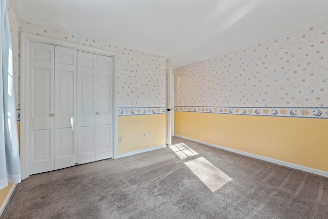 unfurnished bedroom featuring carpet floors and a closet