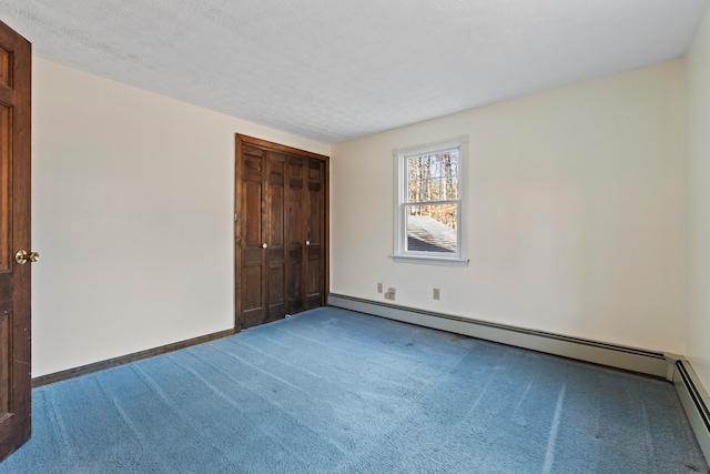 unfurnished bedroom featuring a textured ceiling, carpet floors, and a baseboard radiator