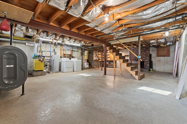 basement featuring independent washer and dryer and electric water heater