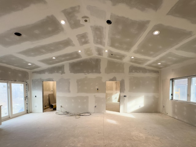 spare room with a healthy amount of sunlight and vaulted ceiling