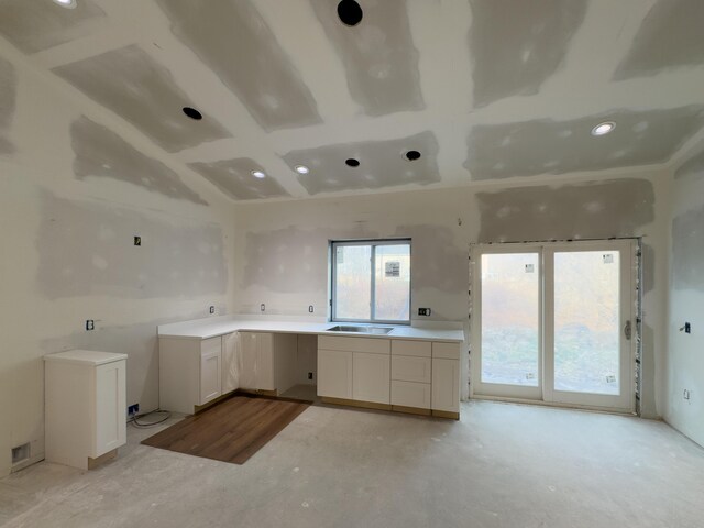 kitchen featuring white cabinets and sink