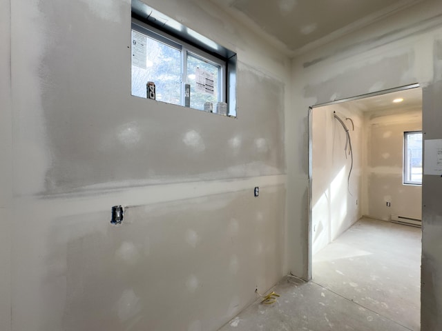 interior space with baseboard heating and plenty of natural light