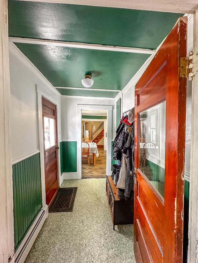 mudroom featuring a wainscoted wall, a baseboard radiator, and crown molding