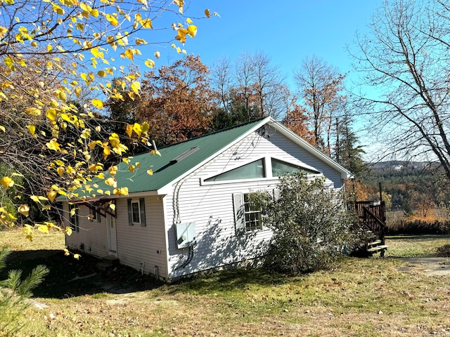 view of home's exterior with a yard