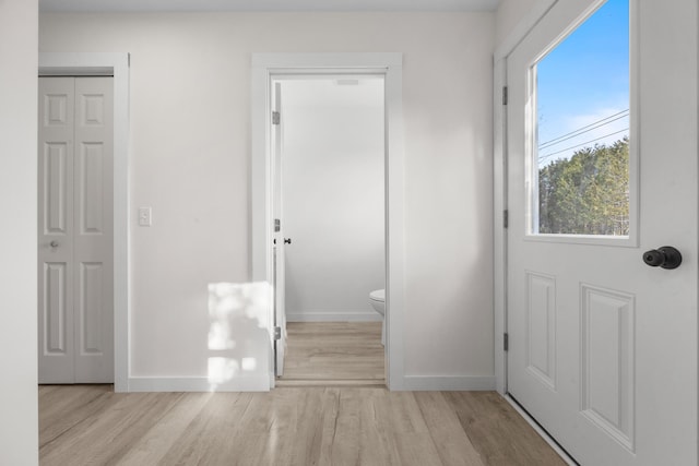 doorway with light wood-type flooring