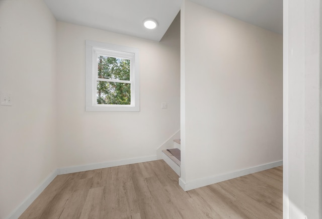 unfurnished room with light wood-type flooring