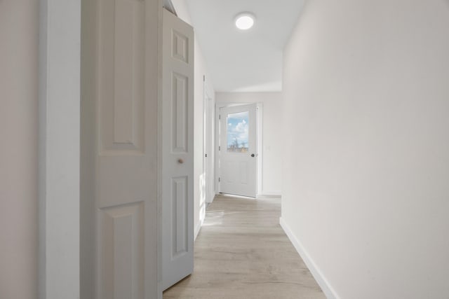 corridor with light hardwood / wood-style flooring