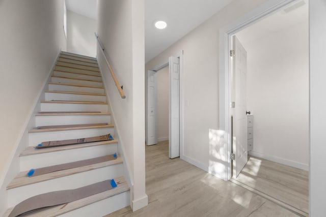 stairway with hardwood / wood-style floors