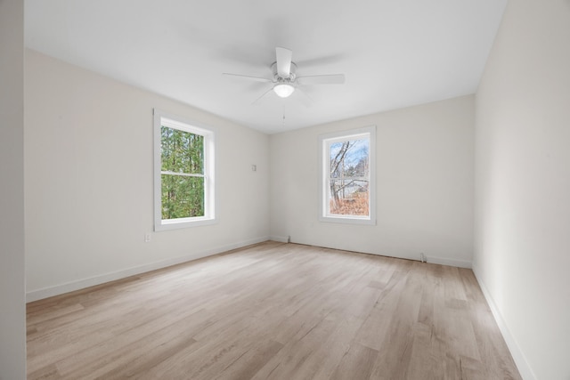 unfurnished room with light wood-type flooring and ceiling fan