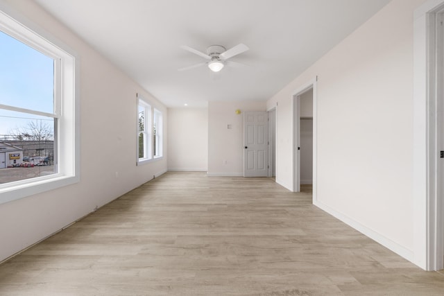 spare room featuring light wood-type flooring and ceiling fan