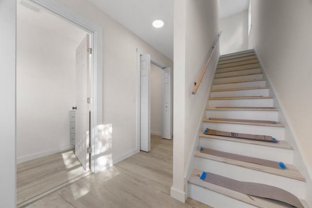 staircase with hardwood / wood-style floors