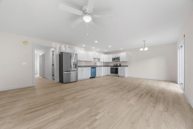 kitchen with white cabinetry, appliances with stainless steel finishes, and light hardwood / wood-style flooring