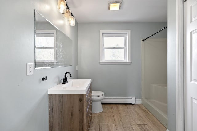 bathroom featuring vanity, a shower, toilet, a baseboard radiator, and wood-type flooring