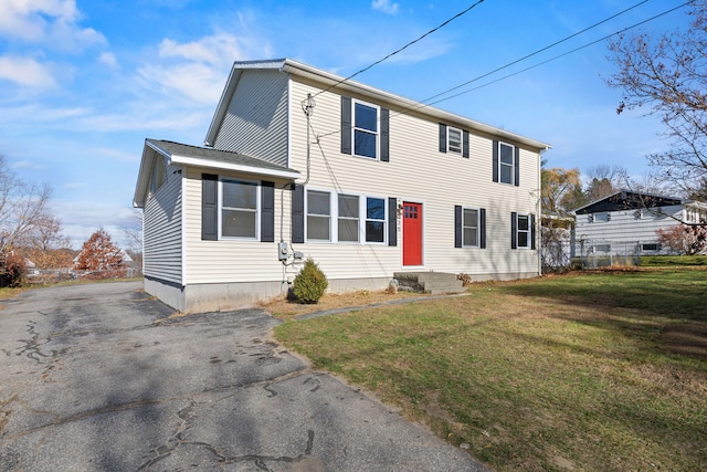 colonial home with a front lawn