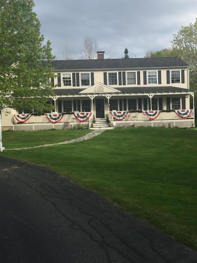 colonial inspired home with a front lawn