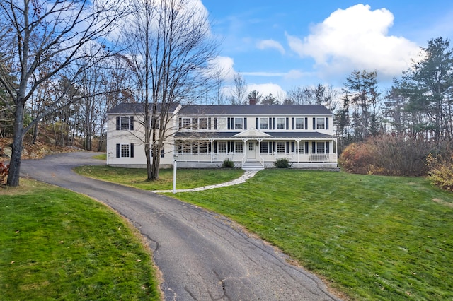 view of front of property with covered porch and a front lawn