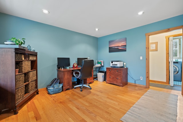 office with light wood-type flooring and washer / clothes dryer