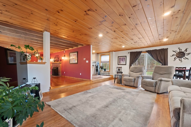 living room featuring a fireplace, hardwood / wood-style floors, and wood ceiling