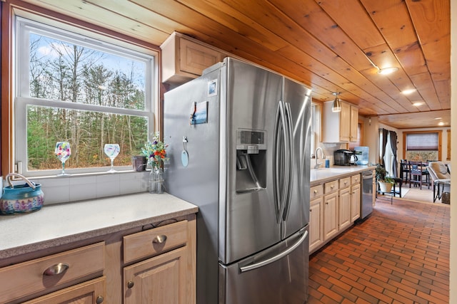 kitchen with light brown cabinets, stainless steel appliances, a wealth of natural light, and wooden ceiling