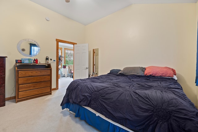 carpeted bedroom featuring lofted ceiling