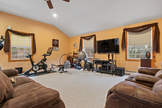 carpeted living room with vaulted ceiling, baseboard heating, plenty of natural light, and ceiling fan