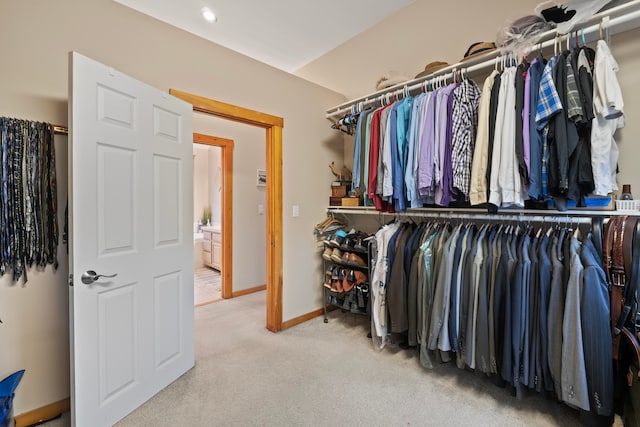 walk in closet featuring carpet flooring