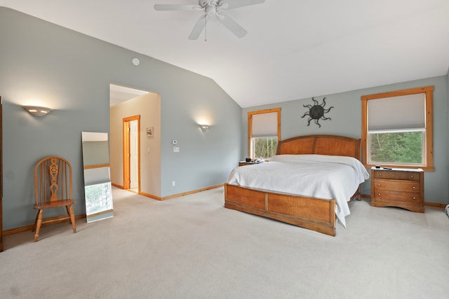 bedroom with light carpet, vaulted ceiling, multiple windows, and ceiling fan